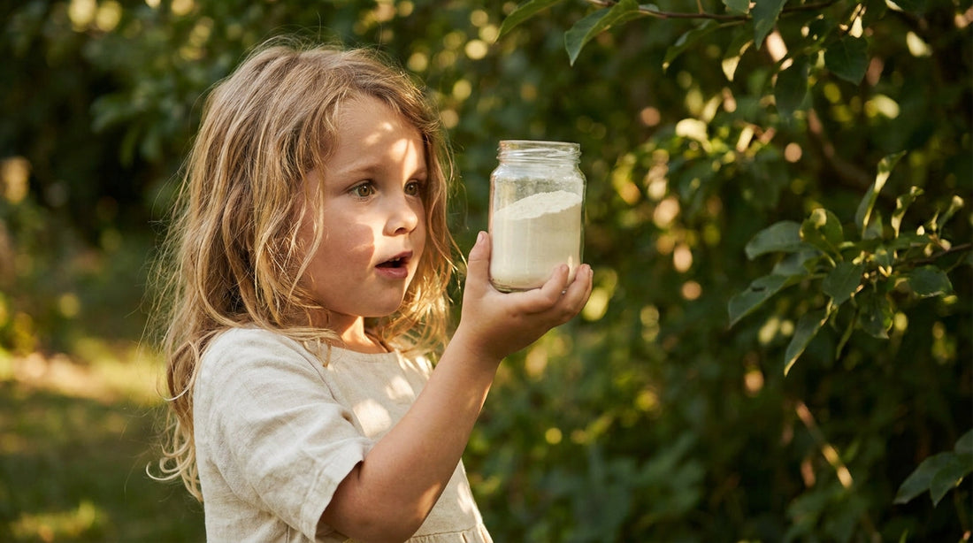 Young girl with wide eyes discovering colostrum powder jar in garden light
