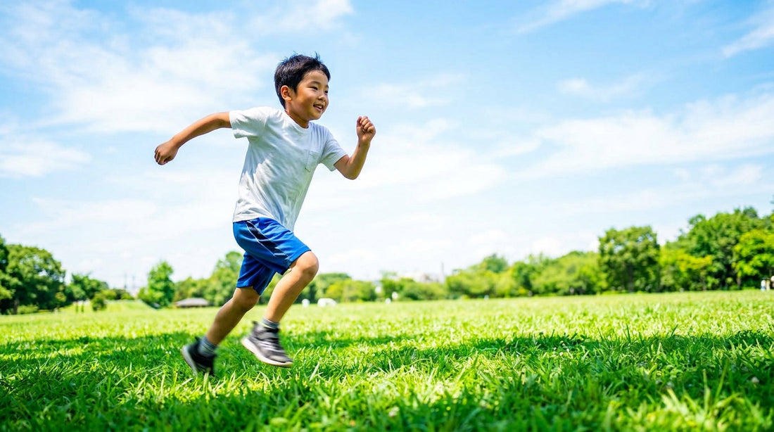 East Asian boy running energetically in a sunlit park — ginkgo biloba brain supplement guide for kids